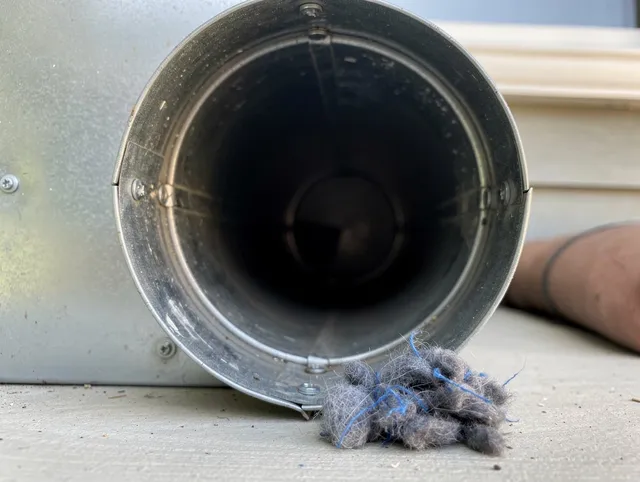 Pompano Beach Dryer Vent Cleaning technician using specialized equipment to clear severe dryer vent blockage in Pompano Beach